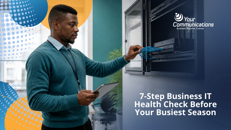 Technician performing a business IT health check on office networking equipment